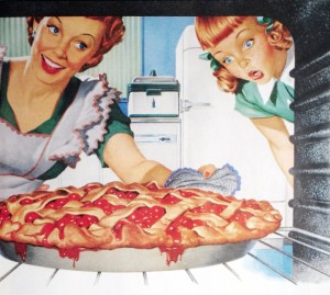 Woman taking cherry pie from oven